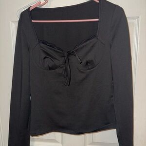 Never worn. Black Long-Sleeve Sweetheart Tie Top. Very nice material.
